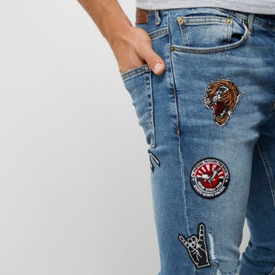 Blue wash ripped badge Sid skinny jeans